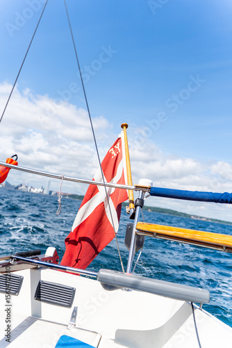 Sailing with Danish Flag Towards Aarhus City Skyline