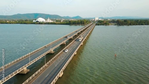 Wallpaper Mural Cars travel on a bridge over the sea with a city skyline in the distance Torontodigital.ca
