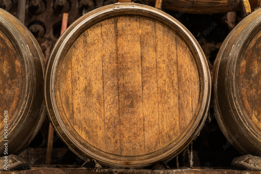 Wine cellar with oak barrels aging showing the concept of winemaking tradition Wine cellar with oak barrels aging showing the concept of winemaking tradition
