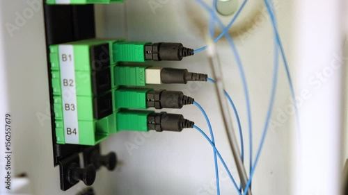 4 APC optical fiber connectors inside the DMARC, routing internet into the home