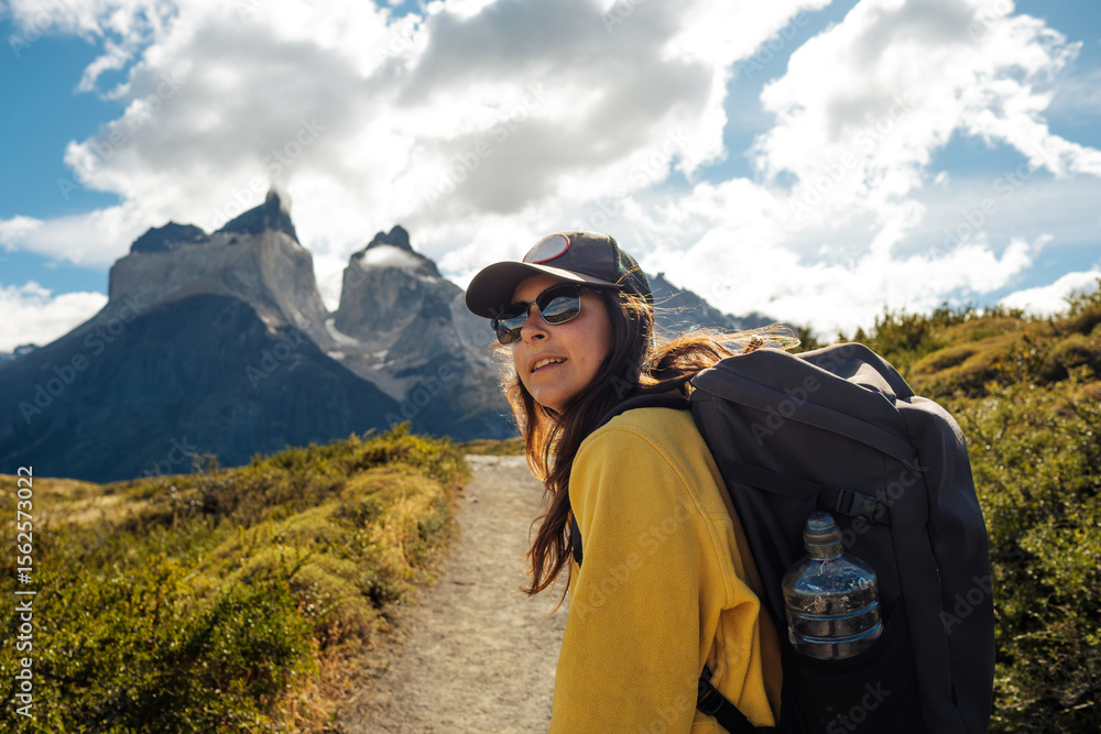 Adventurous Woman Hiking in Majestic Mountain Landscape Adventurous Woman Hiking in Majestic Mountain Landscape