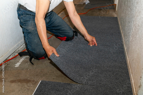 worker installing carpet