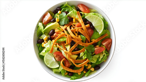 Colorful vegan taco salad with romaine lettuce, black beans, corn, avocado, tomatoes, tortilla strips, lime, and cilantro, ideal for plant-based eating
