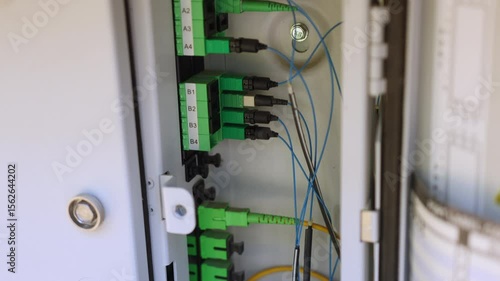 Multiple APC optical fiber connectors inside the DMARC, routing internet into the home 