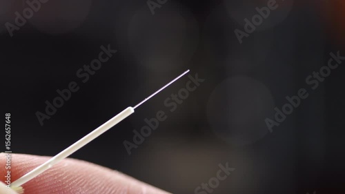 Close-up of a cleaned and cleaved optical fiber, ready for connector insertion