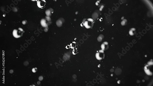 Abstract black and white bubbles rising slowly background animation