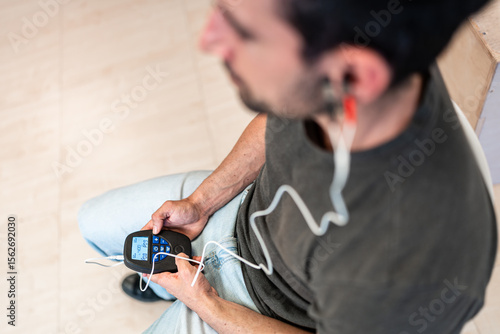 Pacient using electrodes for electromyography on ear