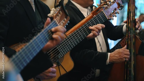 Musician playing guitar in a trio, mexican music, boleros 