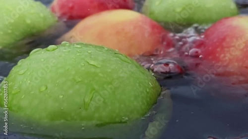 Apple splashed, dripped, swirling in water, radiating a crisp, refreshing sensation. Horizontal Video.