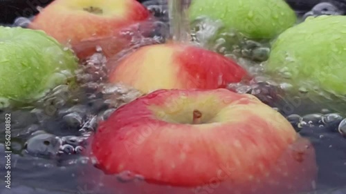 Apple splashed, dripped, swirling in water, radiating a crisp, refreshing sensation. Horizontal Video.