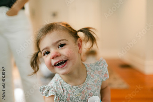 portrait of smiling little girl drinking milk 