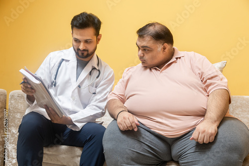 Картината върху платно Male indian doctor consulting with overweight patient