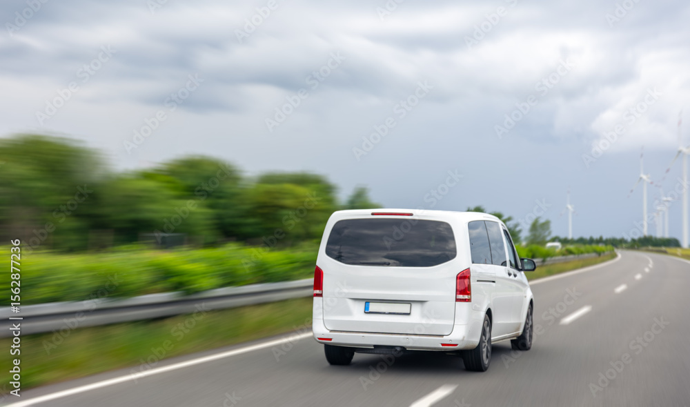 Minivan on road. Rear driving car. Modern highway. Minivan on road. Rear driving car. Modern highway.