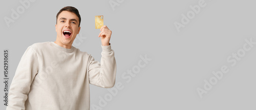 Happy young man with credit...