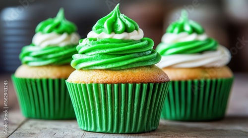 Three cupcakes with vibrant green frosting