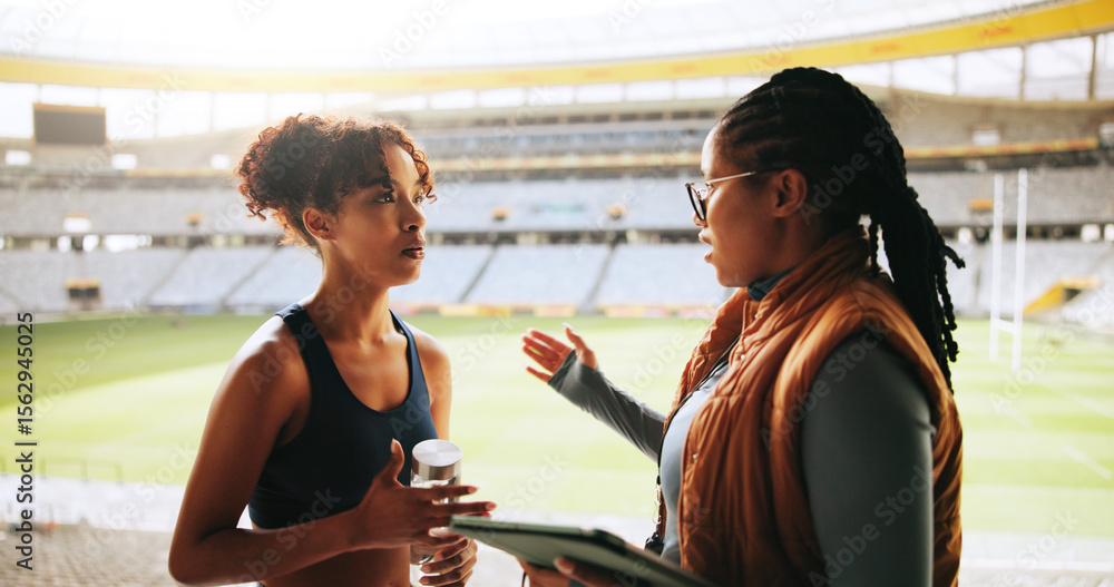 Fototapeta premium Women, sports coach and player with conversation, advice or feedback with training. People, personal trainer or professional athlete with discussion, planning or outdoor stadium with schedule or help