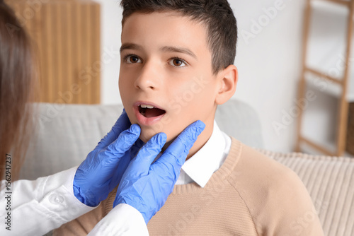 Sick little boy showing sor...