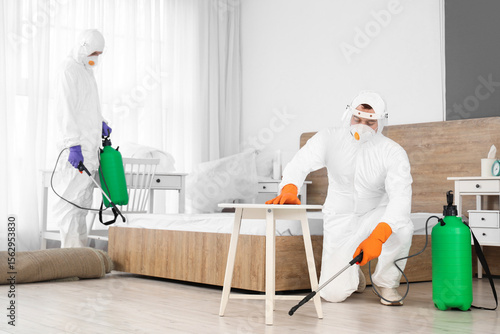 Male workers in hazmat suit...