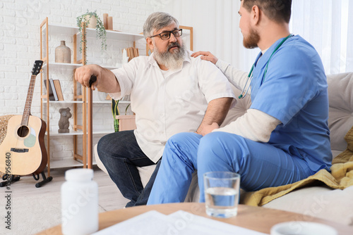 Senior man with stick and c...