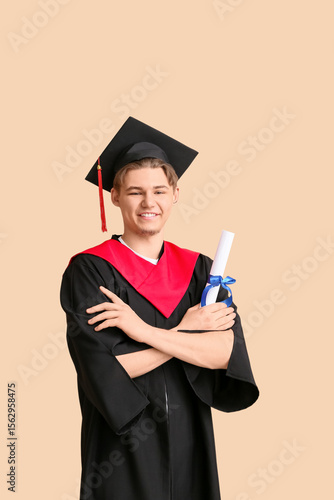Happy male graduate with di...