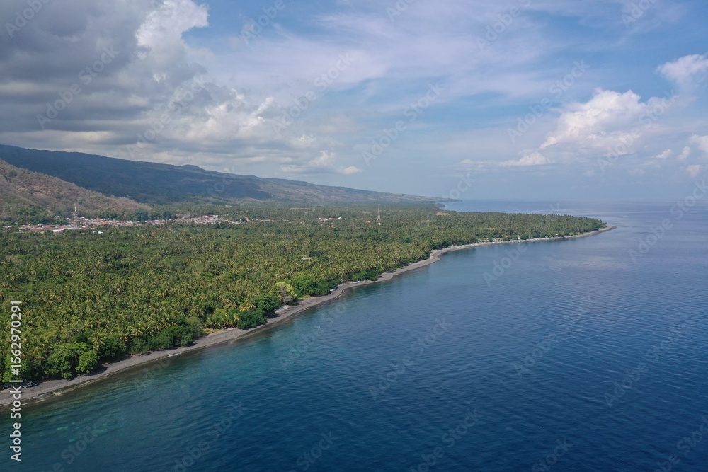 Dramatic Coastal Landscape of North Bali with Jungle Shoreline and Mountain Range Dramatic Coastal Landscape of North Bali with Jungle Shoreline and Mountain Range