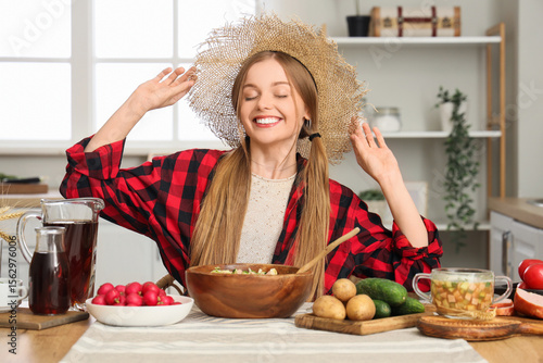 Young woman in straw hat co...
