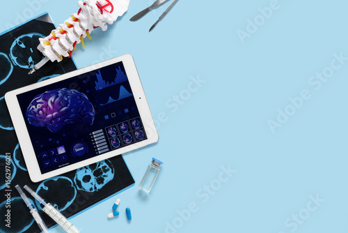 Tablet computer with medical supplies on blue background. Telemedicine concept