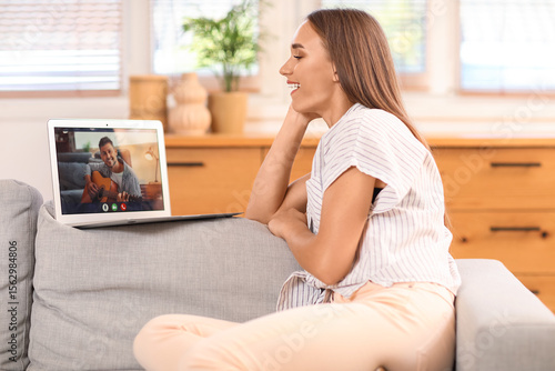 Young woman video chatting ...