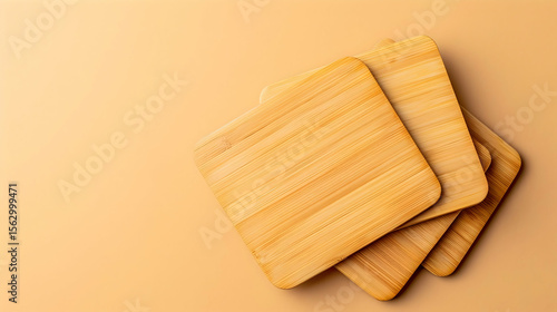 Three wooden coasters stacked on a beige surface.