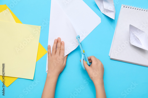Child's hands cutting paper...