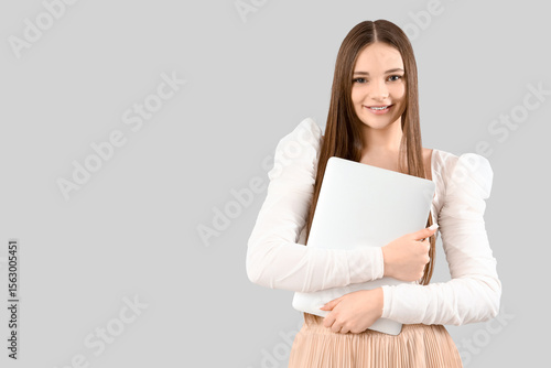Young woman with laptop on ...