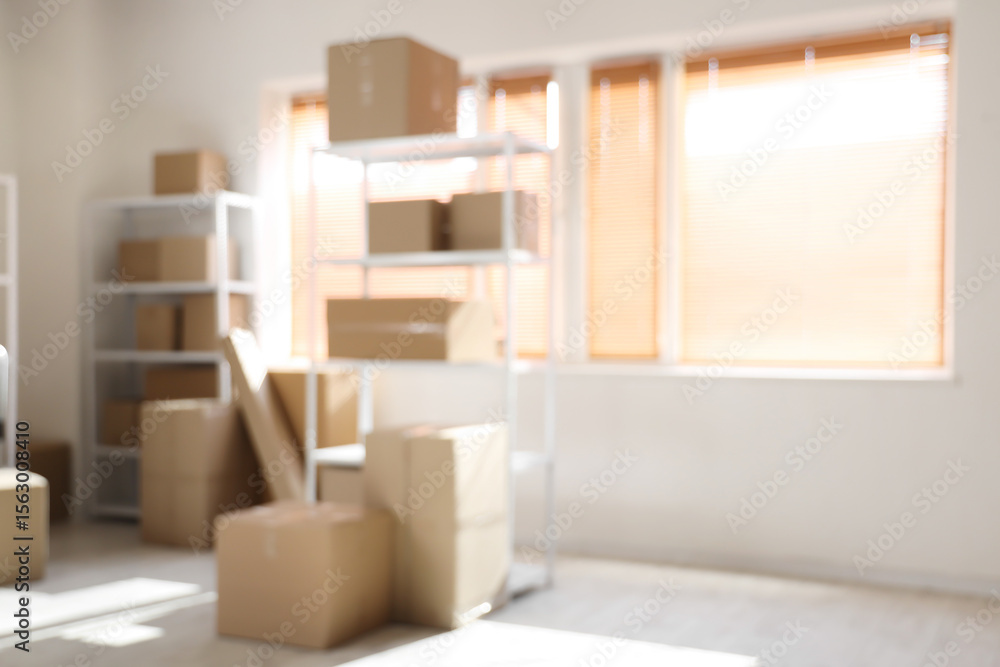 Blurred view of light warehouse with cardboard boxes on shelving units Blurred view of light warehouse with cardboard boxes on shelving units