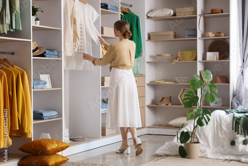 Young woman choosing clothe...