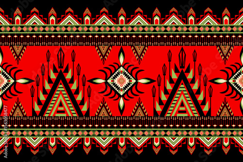 Seamless geometric ethnic pattern featuring bold red, green, and black motifs inspired by tribal art.  Traditional textile, triangles, diamond shapes for fabric, print, background, carpet, wallpaper.
