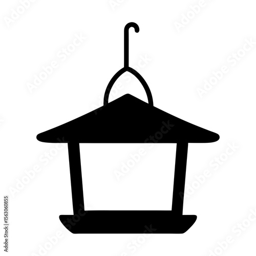 Black silhouette of a hanging bird feeder with a hook and roof