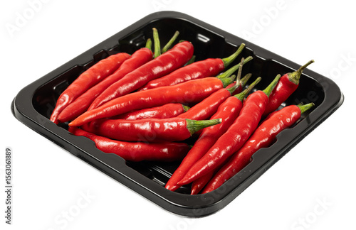 Fresh red chili peppers on black tray vibrant spicy vegetables raw cayenne ingredient for cooking
