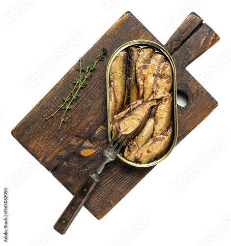 Smoked sardines in open tin can on rustic wooden board with green herbs and vintage fork, savory seafood presentation, textured golden fish, dark background, fresh and appetizing