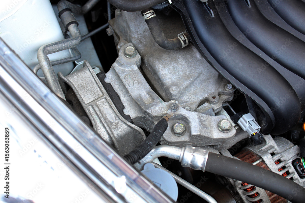Obraz premium Upper engine mount close up. Gasoline engine parts. Engine mount in the upper part of car. Engine parts under the hood of the car.