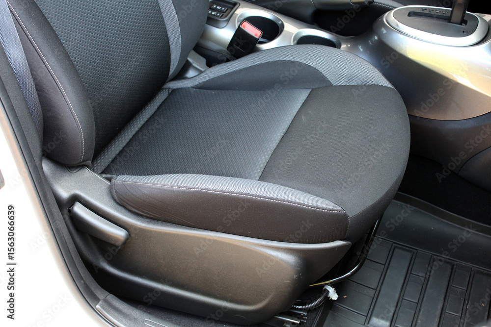 Fototapeta premium Gray textile drivers seat in a luxury SUV. Fabric car interior. Gray drivers seat in the car. Front seats of a modern passenger car.