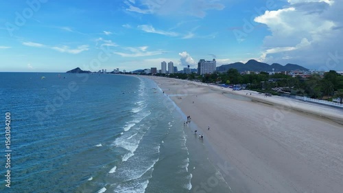 Clean sandy beach stretching along Thai coastal resort town