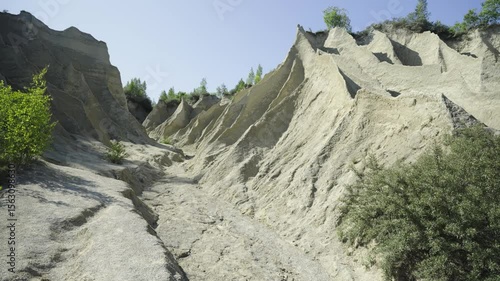 Abandoned limestone quarry. Beautiful nature, landmark of Estonia. Summer season. Rummu quarry lake with an underwater prison in the middle. Bulk mountains of the limestone quarry. 