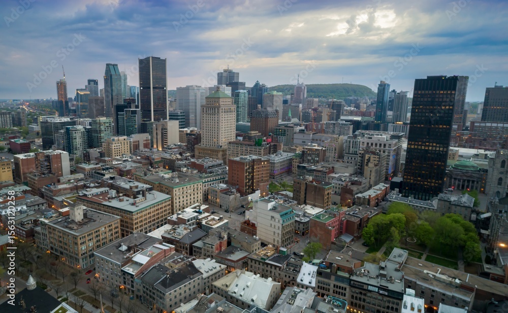 Fototapeta premium Montreal, Canada cityscape at dusk. Aerial view of the city's architecture, including skyscrapers and historic buildings, showcasing urban development and design.