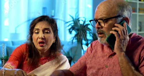 Senior couple and cyber scam while making online payment using computer at home, retired Indian husband wife calling customer care or police after facing digital fraud, financial scam, monetary loss