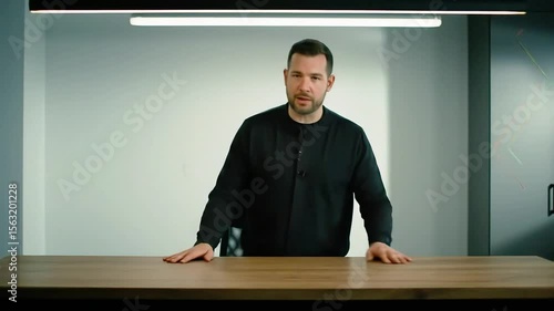 Confident Professional Man Explaining at Desk in Modern