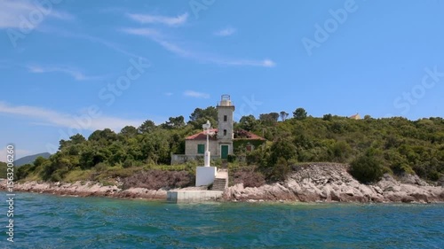 Abandoned Blace Lighthouse on Pelješac Peninsula Croatia with Stone Tower, Green Doors, Overgrown Vegetation and Adriatic Sea Coastline Seen in Summer Sunny Weather