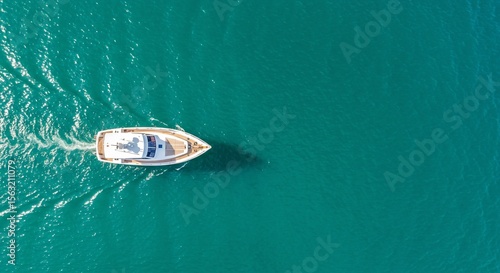 Aerial View of White Yacht Cruising Teal Ocean Waters