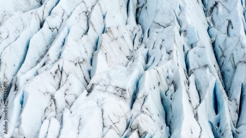 Wallpaper Mural Aerial view of a massive glacier featuring deep crevasses and textured ice formations, creating a stunning abstract landscape. Torontodigital.ca