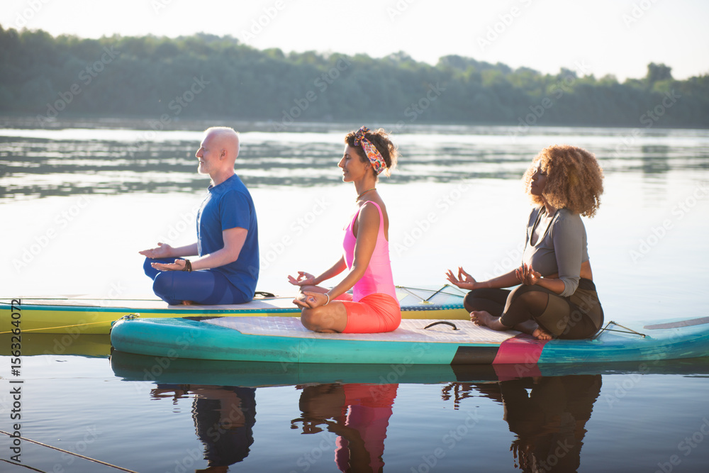Fototapeta premium Multicultural Group Meditation on Water: Inclusive Wellness in Action