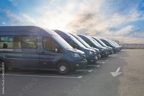 Series of new vans are parked in rows