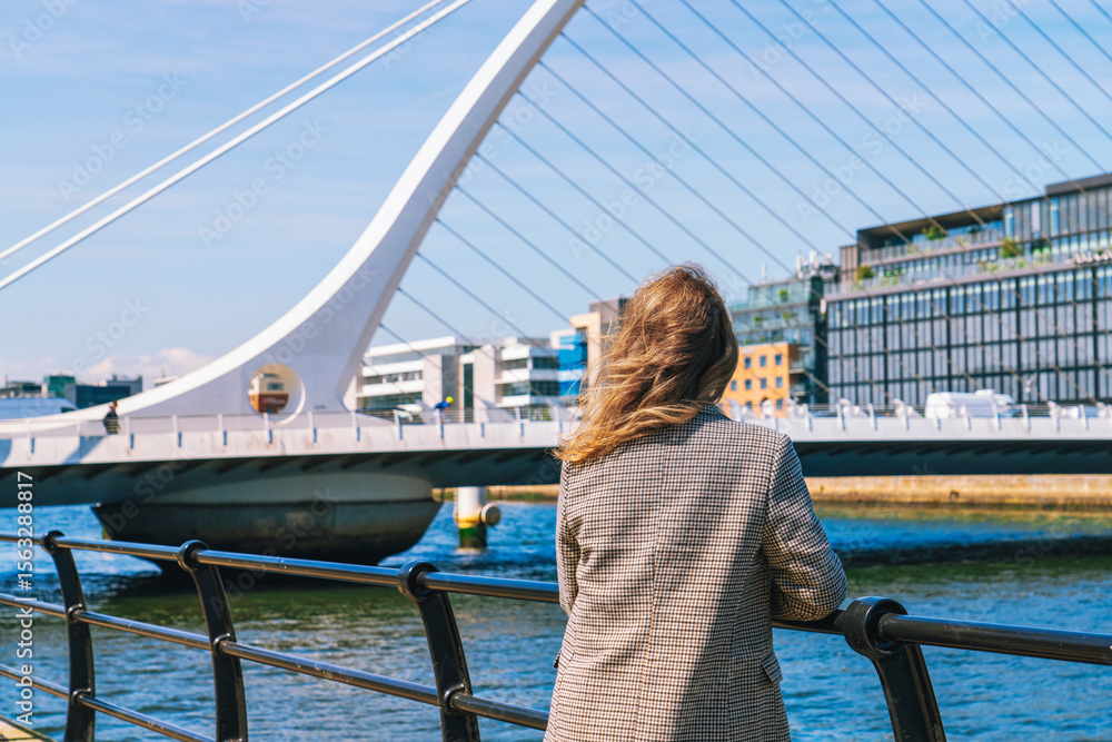 Naklejka premium Woman looking at Samuel Beckett's bridge in Dublin Ireland